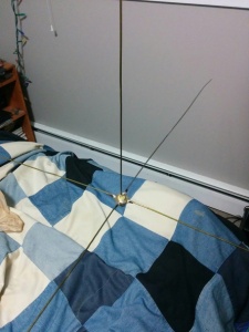 A ground plane antenna made from a panel mount UHF connector and 5 segments of clothes hanger wire.